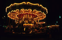 Old-fashioned carousel light up at night by Sami Sarkis Photography