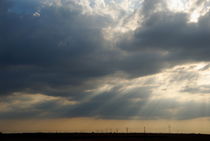 Sun shining through clouds by Sami Sarkis Photography