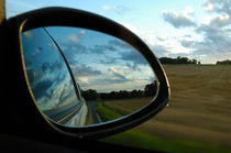Close-up of side-view mirror reflecting clouds by Sami Sarkis Photography