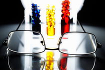 Spectacles and three colorful test tubes von Sami Sarkis Photography