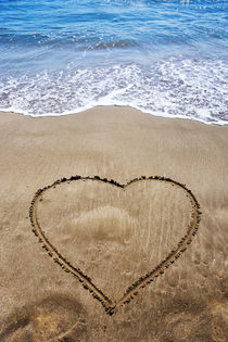 Heartshape drawn in sand on beach by Sami Sarkis Photography