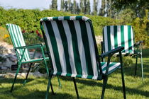 Empty seats on garden lawn von Sami Sarkis Photography