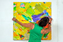 Woman adjusting a painting by Sami Sarkis Photography