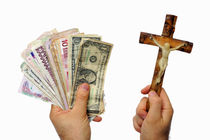 Man's hand with international banknotes and crucifix by Sami Sarkis Photography
