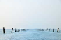 Wooden posts along canal by Sami Sarkis Photography