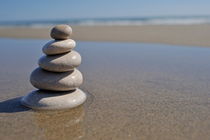 Stack of pebbles on beach by Sami Sarkis Photography