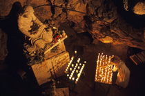 Woman burning candle at Troglodyte Sainte-Marie Madeleine Holy Cave von Sami Sarkis Photography