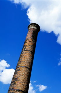 Brick smoke stack emitting smoke by Sami Sarkis Photography