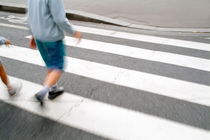 Children walking across a zebra crossing on a city street by Sami Sarkis Photography