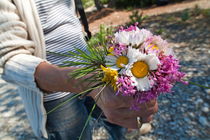 Woman holding a bunch of colorful flowers. by Sami Sarkis Photography