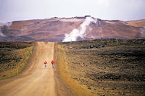 Two bikers on a dirt road leading to a geothermal power station at Myvatn by Sami Sarkis Photography