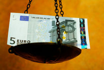 Scale weighing a five Euro banknote. by Sami Sarkis Photography