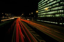 Traffic on a city highway at night near La Défense business district by Sami Sarkis Photography