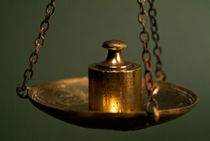 Group of French copper weights hanging on a scale. von Sami Sarkis Photography