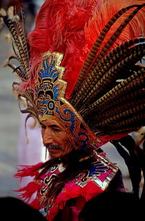 Man in traditional headdress to celebrate the Day of the Virgin of Guadalupe on December 12th in Mexico City by Sami Sarkis Photography