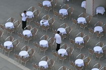 Waiters at empty cafe terrace on Piazza San Marco by Sami Sarkis Photography
