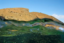 Bartolome Island rock and water surface (split shot half underwater) von Sami Sarkis Photography