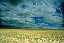 Dramatic cloudy sky passing over the rock formations in Monument Valley by Sami Sarkis Photography