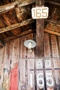 Light hanging inside an old wooden hut by Sami Sarkis Photography