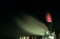 Illuminated chimney at a petroleum refinery by Sami Sarkis Photography