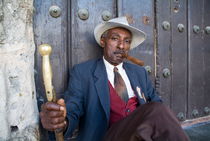 Portrait of a man wearing a 1930s-style suit and smoking a cigar by Sami Sarkis Photography