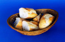 Basket of french baguette slices by Sami Sarkis Photography