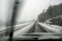 Car driving on a snowy road in the winter. by Sami Sarkis Photography