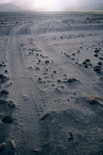 Tyre tracks and lava rocks on the vast ash plain near Mount Yasur by Sami Sarkis Photography