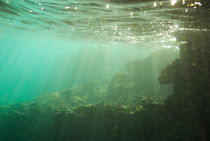 Sunrays penetrating underwater cave near surface by Sami Sarkis Photography