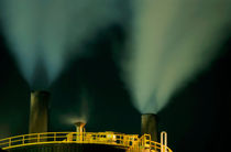 Petroleum refinery chimneys at night by Sami Sarkis Photography