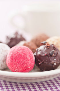 Assorted chocolate truffles on a plate by Lars Hallstrom