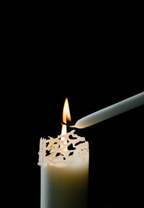 Lighting a candle in a church by Lars Hallstrom