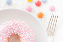 Pink donut with sprinkles by Lars Hallstrom